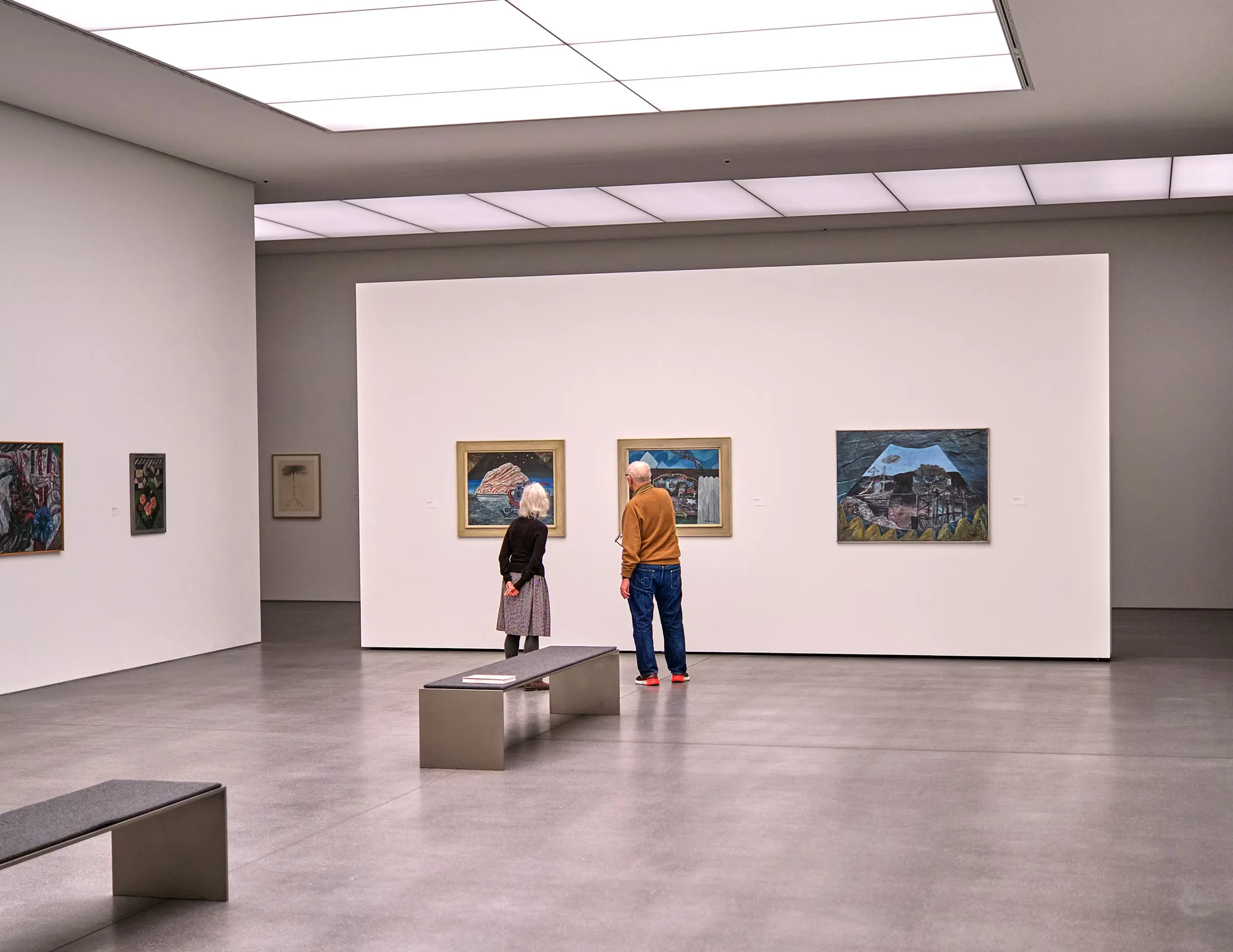 Two people looking at art in a modern art gallery
